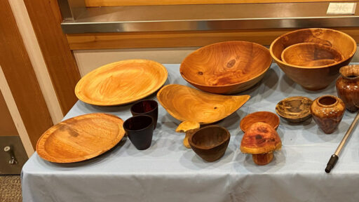 Hand-made bowls, platters, cups, and two mushrooms turned by Kelly Smith. The two vases on the right are made by Bob Bley.