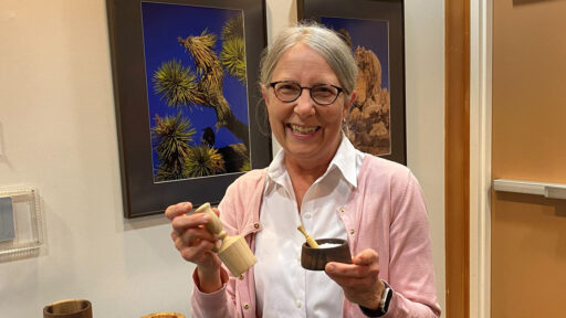 Kirsten shows a wooden scoop and a salt dish that she turned last month.