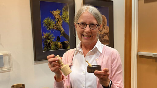 Kirsten shows a wooden scoop and a salt dish that she turned last month.