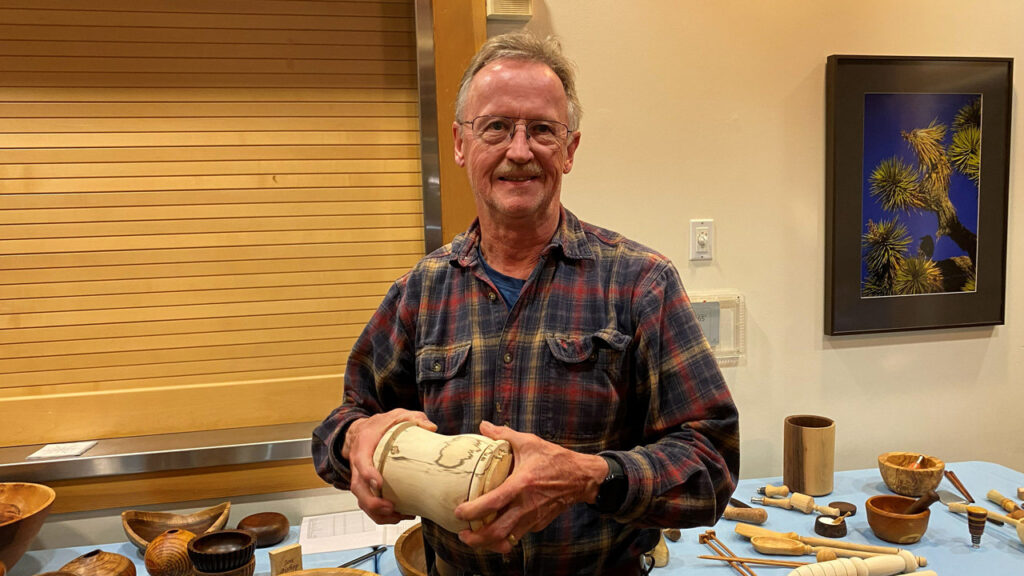 Tom Gaston shows a birch canister that he turned on a lathe.