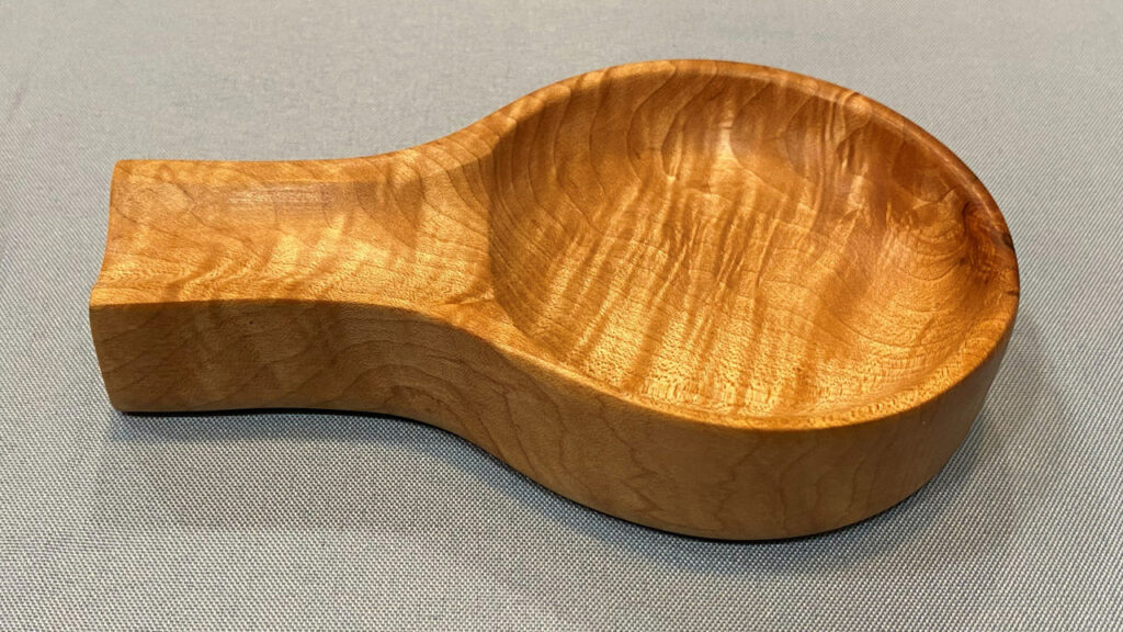 A wooden spoon rest turned and carved from maple by Tom Gaston. Tom finished the item with oil to highlight the beautiful grain.