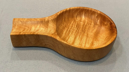 A wooden spoon rest turned and carved from maple by Tom Gaston. Tom finished the item with oil to highlight the beautiful grain.