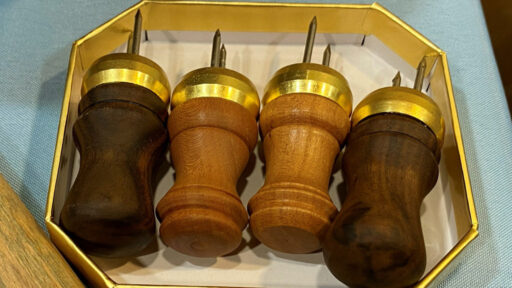 Four corn cob holders turned from various woods.