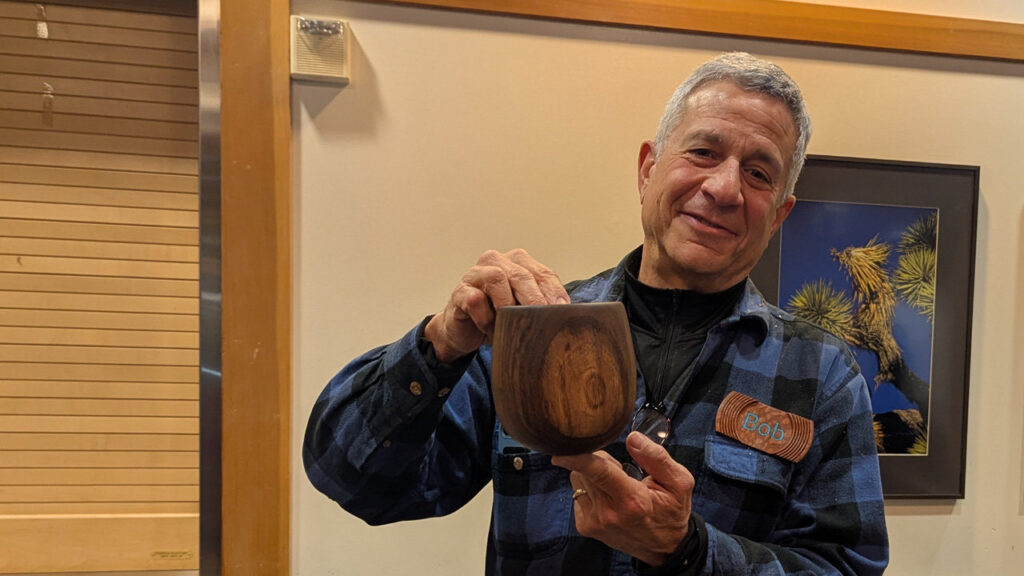 Bob is showing a tall bowl inspired by the shape of a calabash.