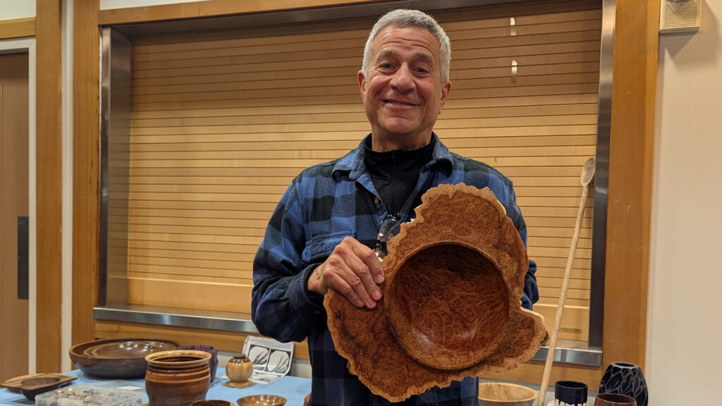 Bob Bley is showing a large winged bowl that he turned from a redwood burl.