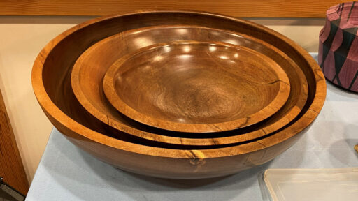 Three large walnut bowls turned on a lathe by Daniel Saal.