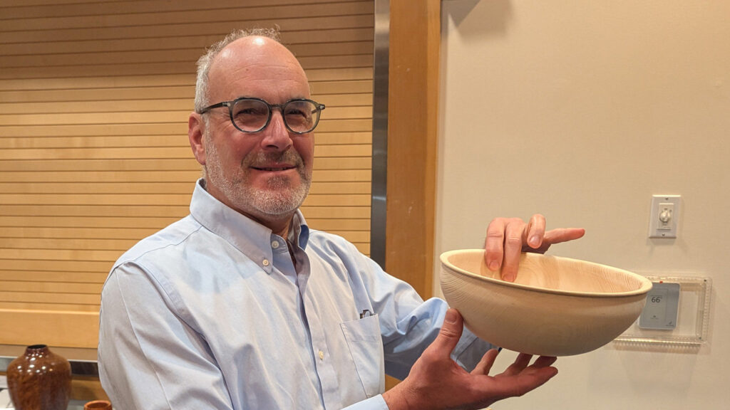 Daniel is showing a calabash bowl with a bead on the rim.