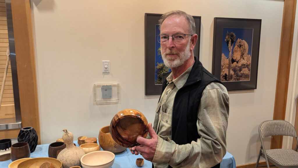 Dean is showing a calabash bowl that he turned from camphor wood.