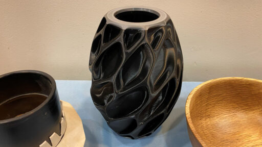A 3D-printed vase using black filament.