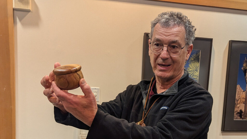 Jon is showing a small calabash bowl with a lid that he turned on a lathe.