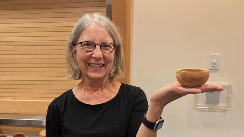 Kirsten is showing a calabash bowl that she recently turned.