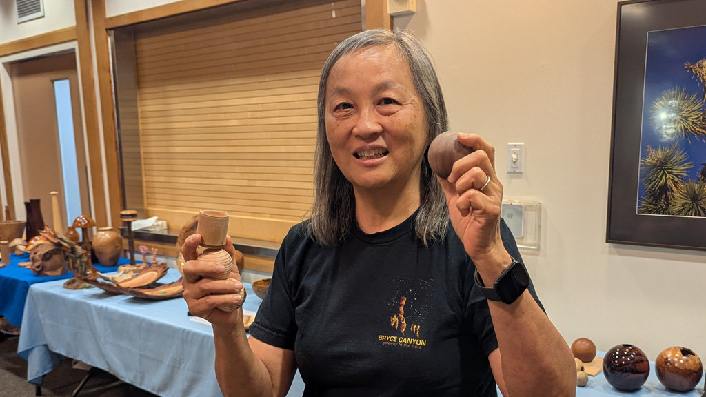 Alison is showing three turned spheres and a stand for a sphere.