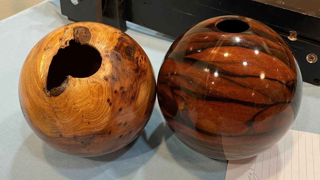 Two wooden spheres with wild grain.