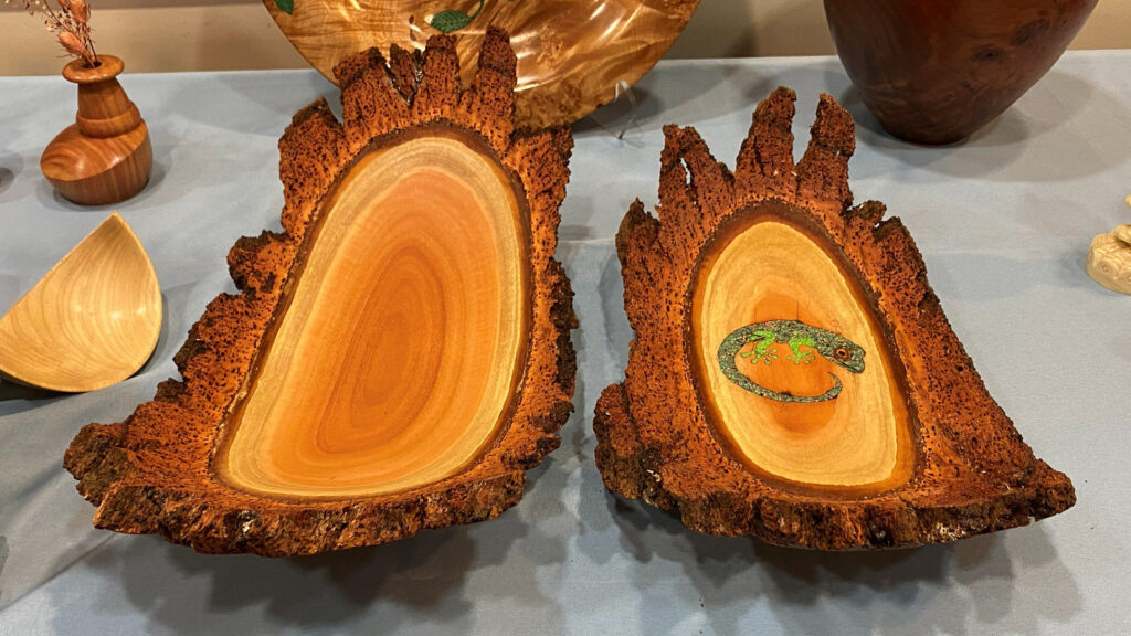Large, natural-edge platters turned by Bob on a lathe. One has a green gecko stone inlay.