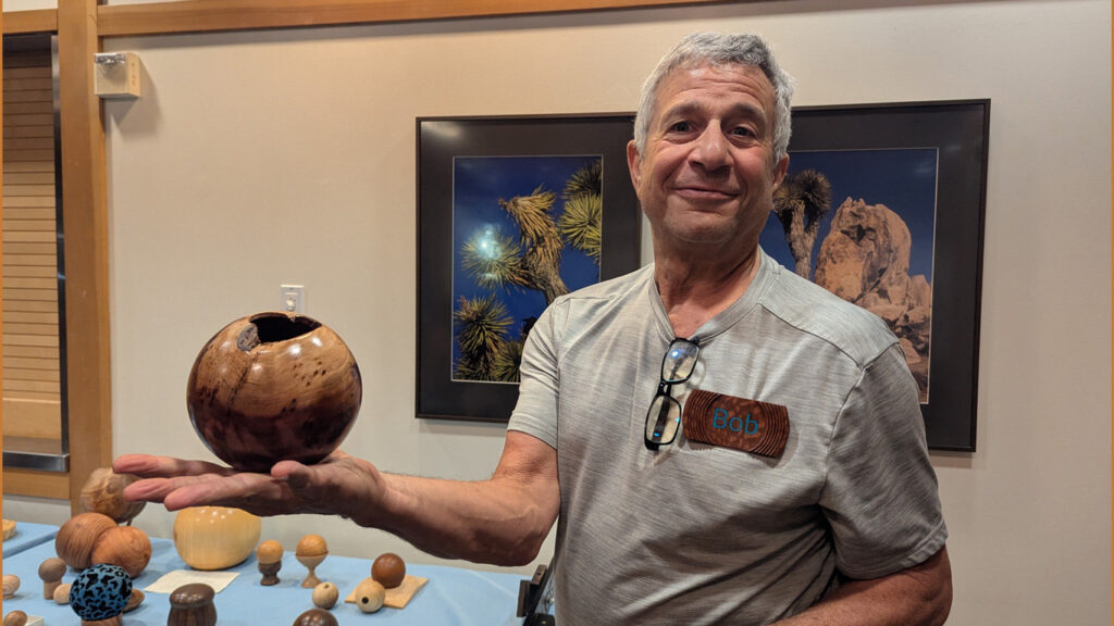 Bob is holding a sphere that he turned on his lathe.
