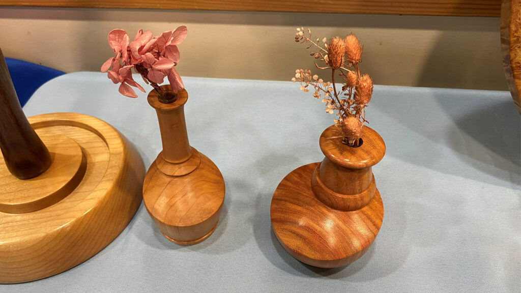 Two offset turned flower vases.