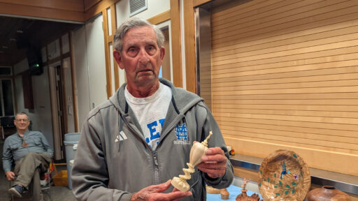 Dale is holding an ivory box that he turned on a rose engine lathe.