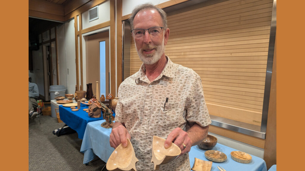Dean is holding two halves of a turned bowl.