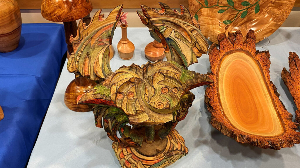 A wooden crab that Derek turned on a lathe. It is also woodburned and painted mostly green.