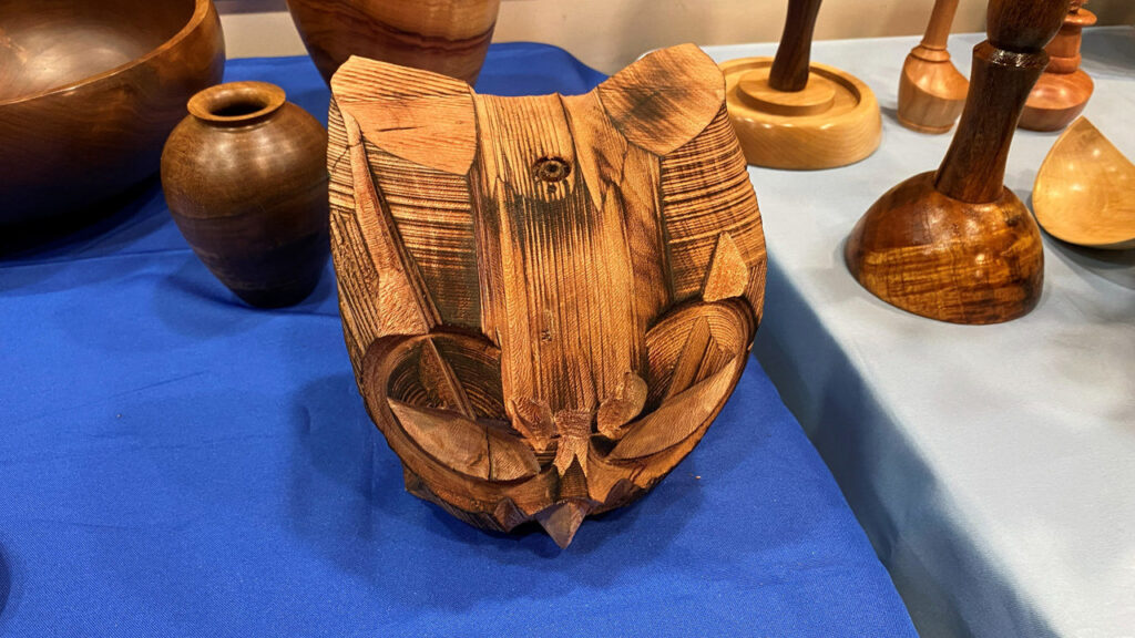 A head of an owl turned on a lathe and woodburned by Derek Weidman in March 2026.