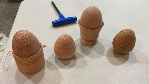 Four eggs turned from Redwood. Two of them are in egg holders.