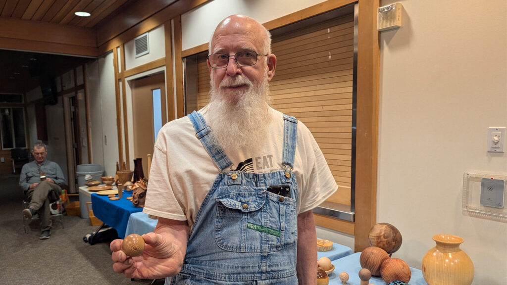 Harvey is holding a small sphere that he turned on a lathe