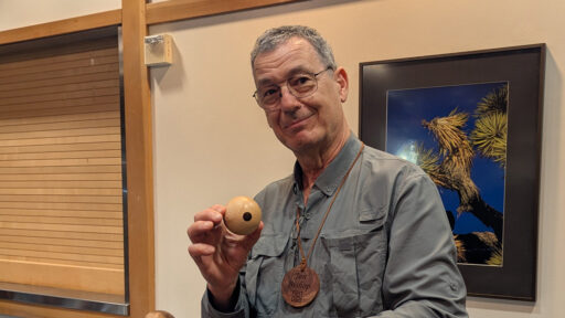 Jon is holding a sphere that he turned on a lathe