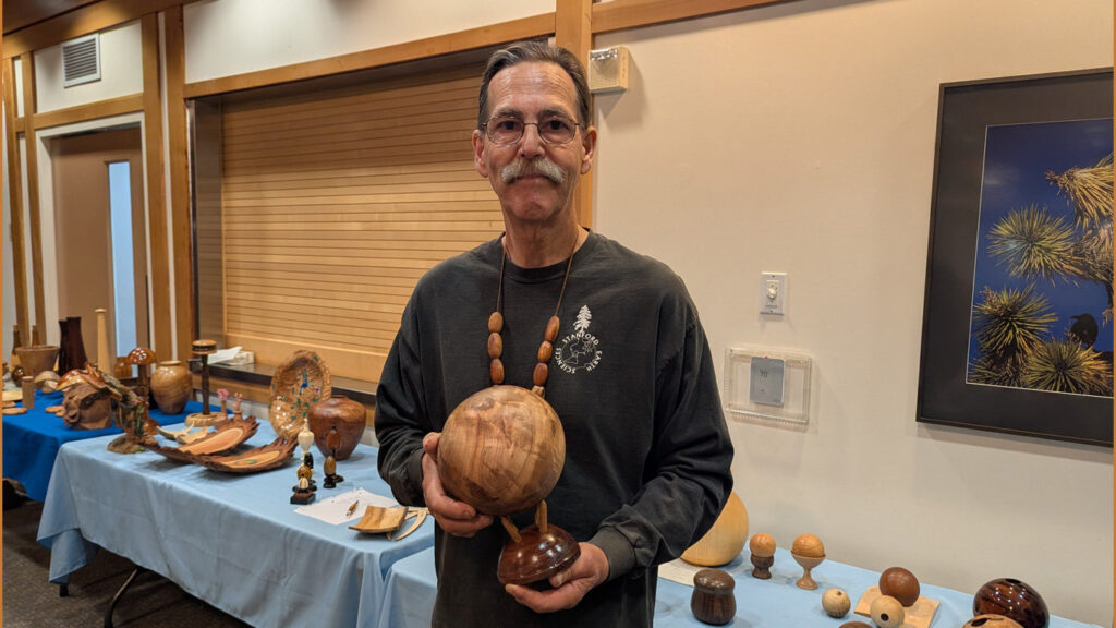 Kelly is showing a sphere with a stand that he turned on a lathe.