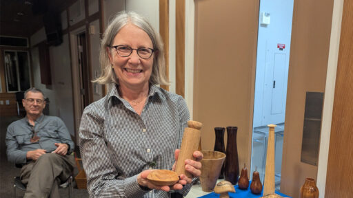 Kirsted is showing two wooden items that she turned on a lathe.