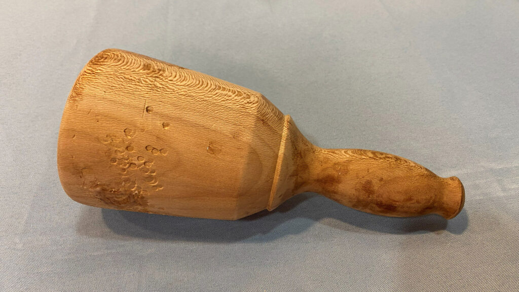 A hand-turned wooden mallet.