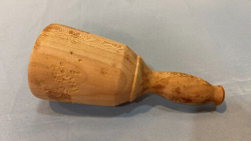 A hand-turned wooden mallet.