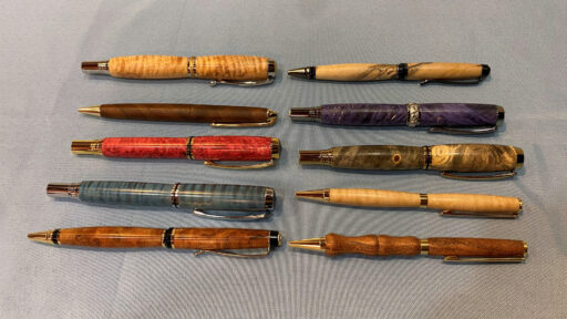 Ten handmade pens were turned from various species of wood by Tina.
