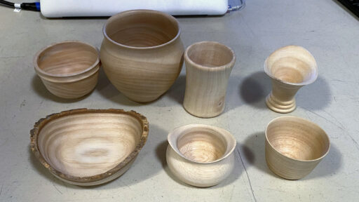 Seven hand-turned wooden vessels by Edgar Whipple, including four crafted from English walnut, were displayed at a West Bay Woodturners monthly meeting.