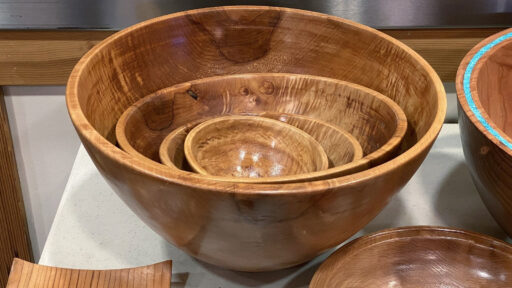 Four glossy nesting broadleaf maple bowls by Kelly Smith, displayed on a table at a West Bay Woodturners meeting in Los Altos, California.