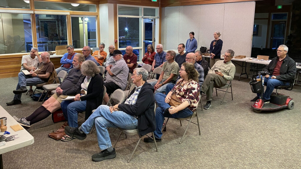 West Bay Woodturners members sit in a community room at Bridges Church in Los Altos, CA, watching Bud Trapp demonstrate multi-axis turning using the Escoulen School and specialized chucks.
