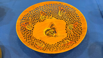 Turned and pierced bowl with butterfly decorations