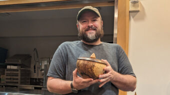 Nate Segraves shows a turned bowl with a lid