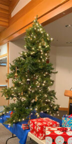 A tree decorated with lights and turned ornaments